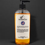 A clear plastic pump bottle of Prohibition Soap hand soap with amber-colored liquid inside, featuring a white label with black text and logo, set against a dark gray background.
