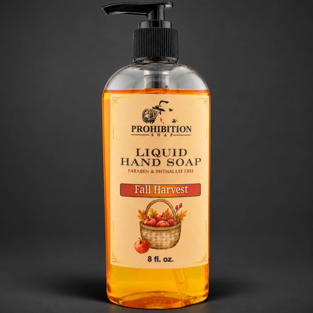 A bottle of Prohibition Soap Liquid Hand Soap in the Fall Harvest scent, featuring amber-colored liquid inside a clear bottle with a black pump dispenser and a beige label.
