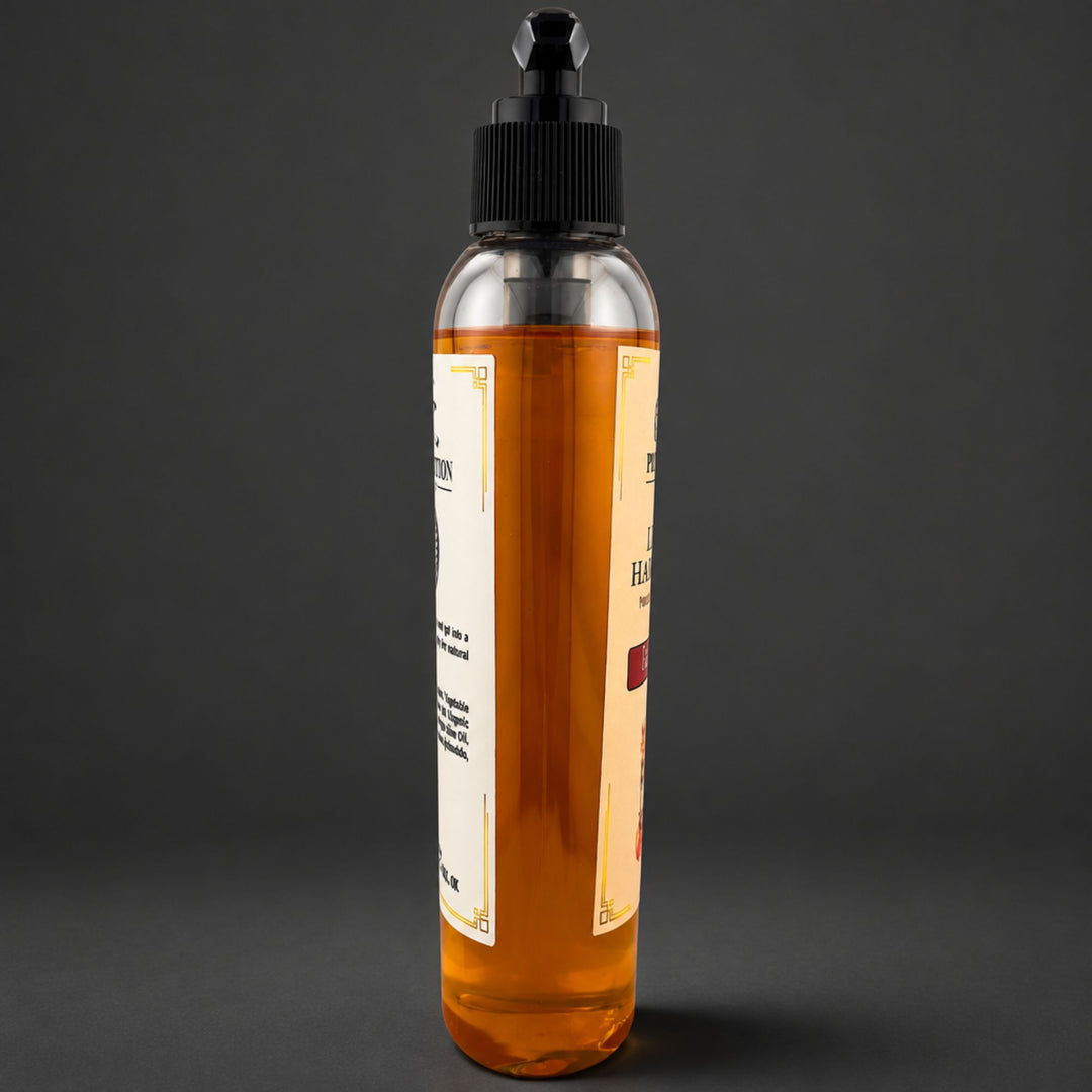 A clear plastic bottle filled with amber-colored soap, featuring a black dropper-style cap and cream-colored labels, set against a dark gray background.