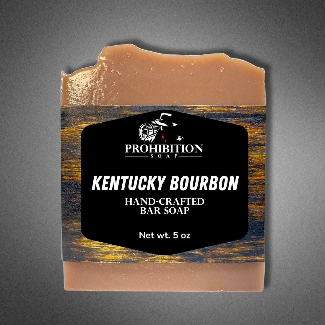Front view of Kentucky Bourbon bar soap with the Prohibition Soap label clearly showing the name, hand-crafted designation, and 5 oz net weight on a gray background