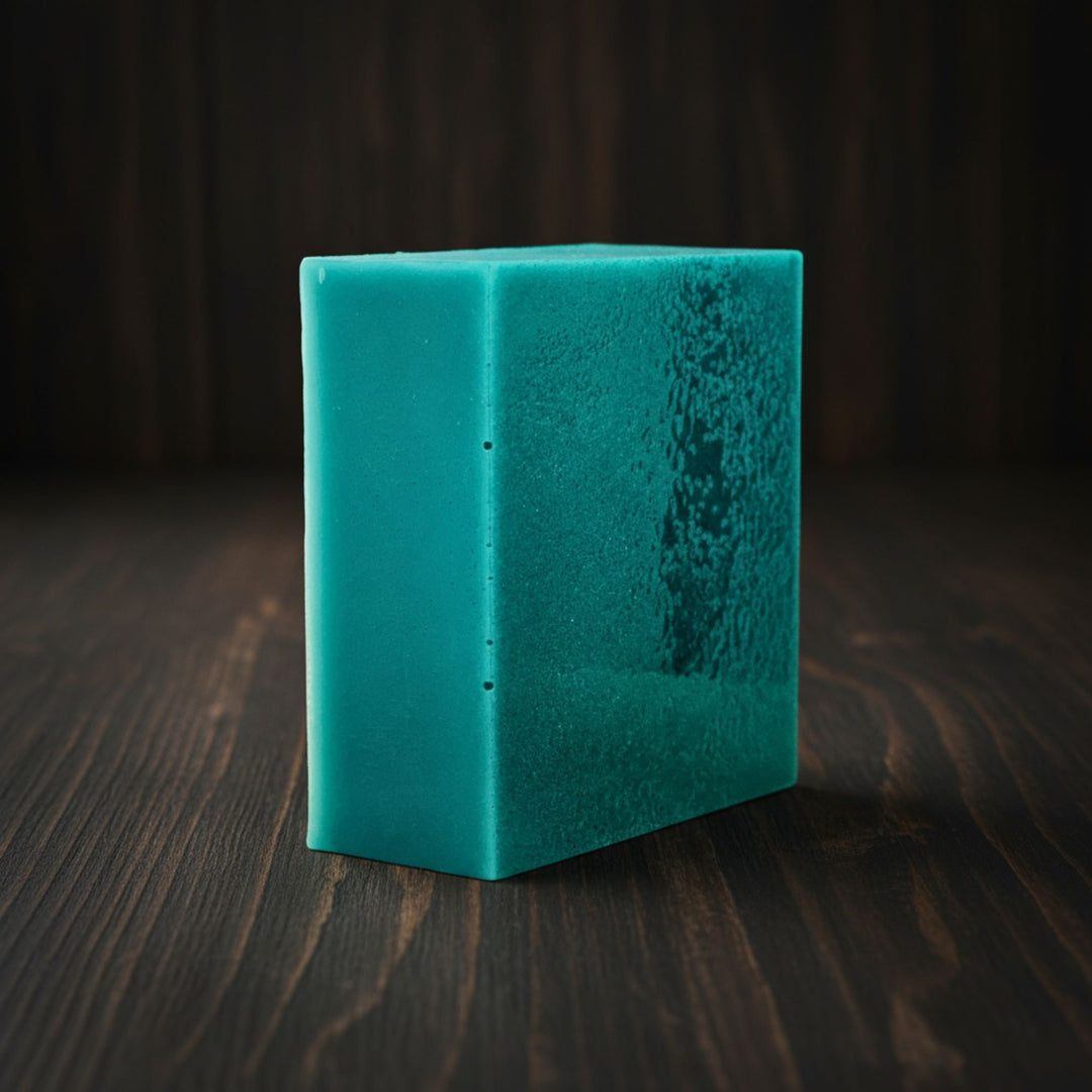 Teal soap on a dark wooden surface