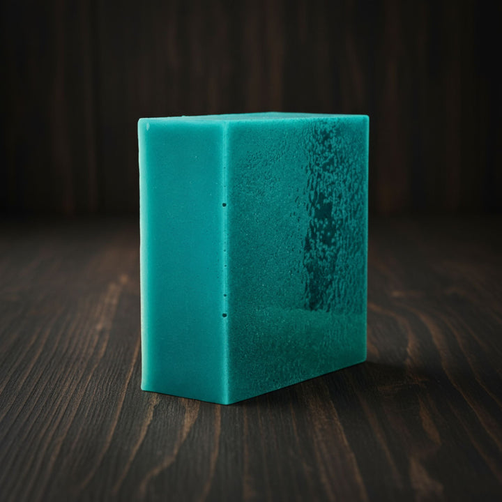 Teal soap on a dark wooden surface