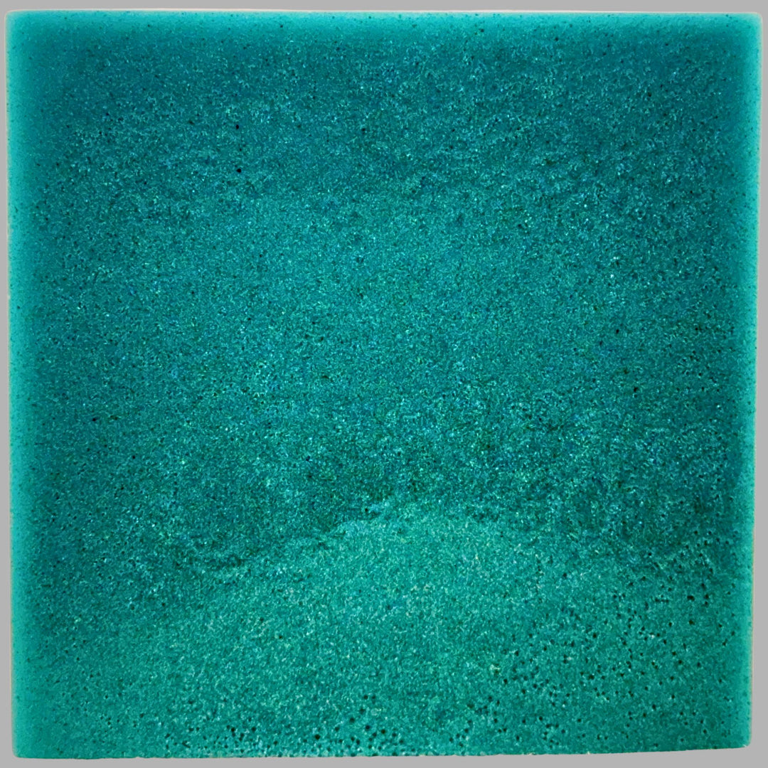 Teal soap on a gray background