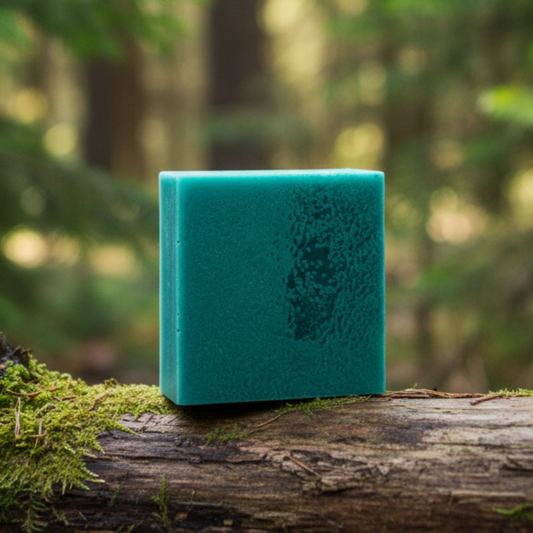 Teal soap on a log with a forest background
