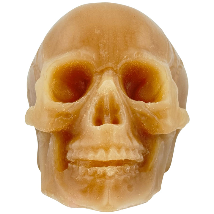 A realistic skull-shaped soap with a warm tan and light brown color, shown against a plain white background.