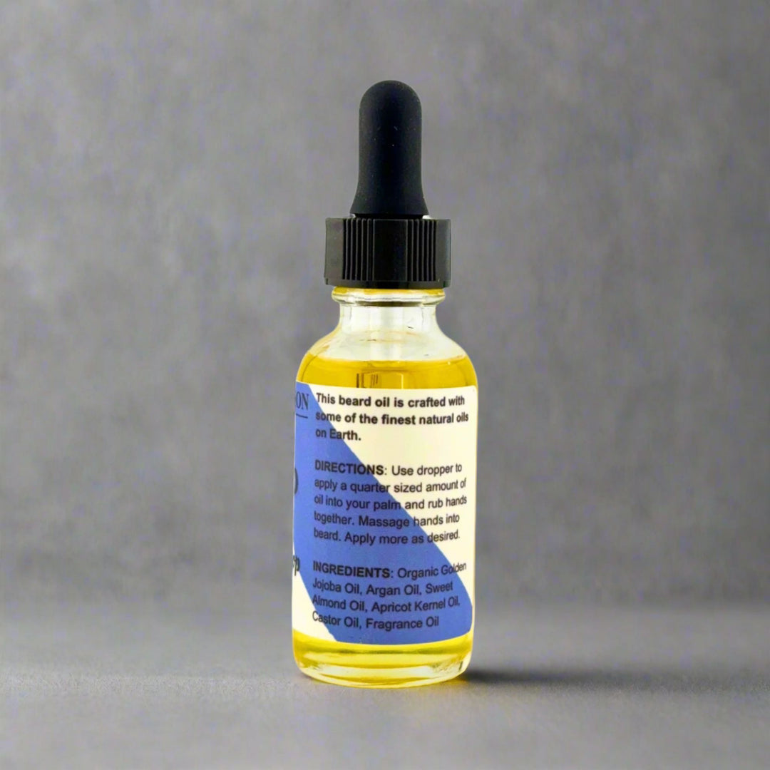 Bottle of beard oil with dropper on a gray background