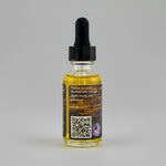 Bottle of beard oil with a dropper on a gray background