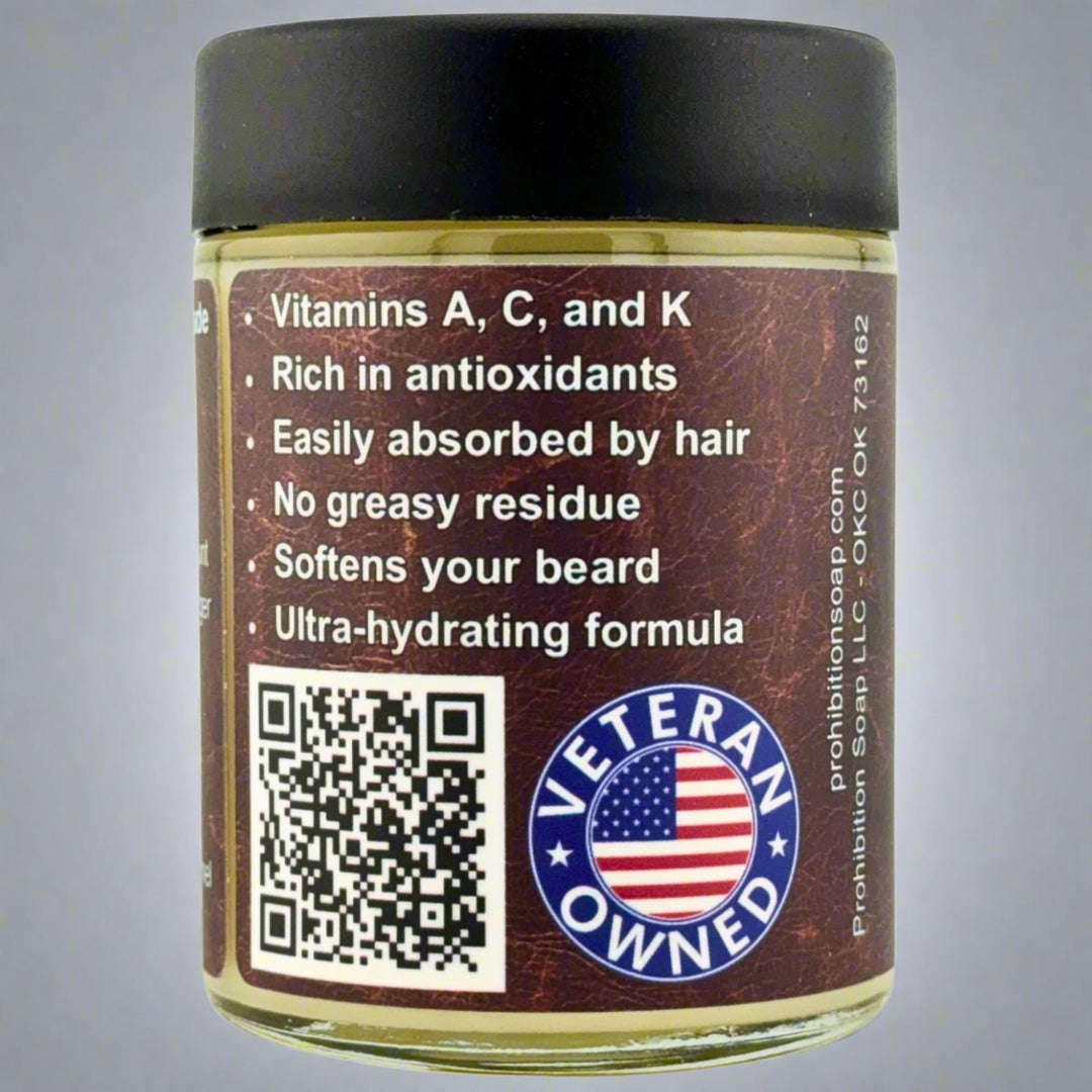 Prohibition Soap Beard Butter in Leather scent - side view showing product benefits including vitamins A, C, and K, rich in antioxidants, easily absorbed by hair, no greasy residue, softens beard, and ultra-hydrating formula, with QR code and Veteran Owned badge