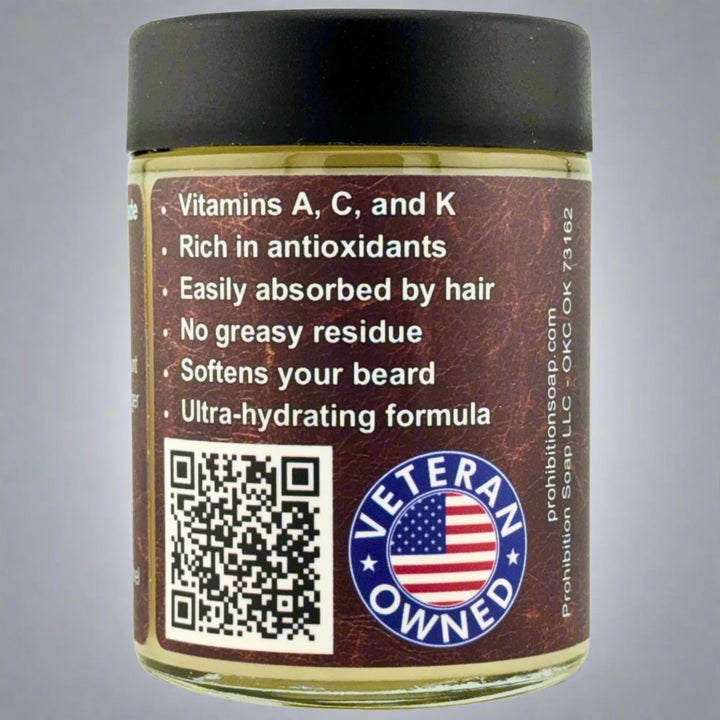 Prohibition Soap Beard Butter in Leather scent - side view showing product benefits including vitamins A, C, and K, rich in antioxidants, easily absorbed by hair, no greasy residue, softens beard, and ultra-hydrating formula, with QR code and Veteran Owned badge