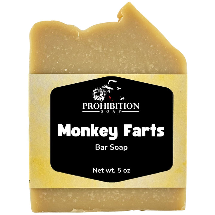 A single bar of handmade soap with a jagged top, wrapped in a cream paper label that reads &