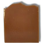 Unwrapped Kentucky Bourbon soap bar showing the smooth, warm amber-brown surface against a white background
