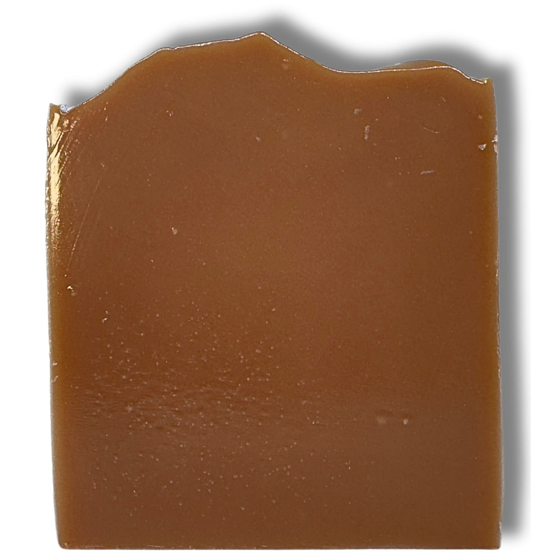 Unwrapped Kentucky Bourbon soap bar showing the smooth, warm amber-brown surface against a white background