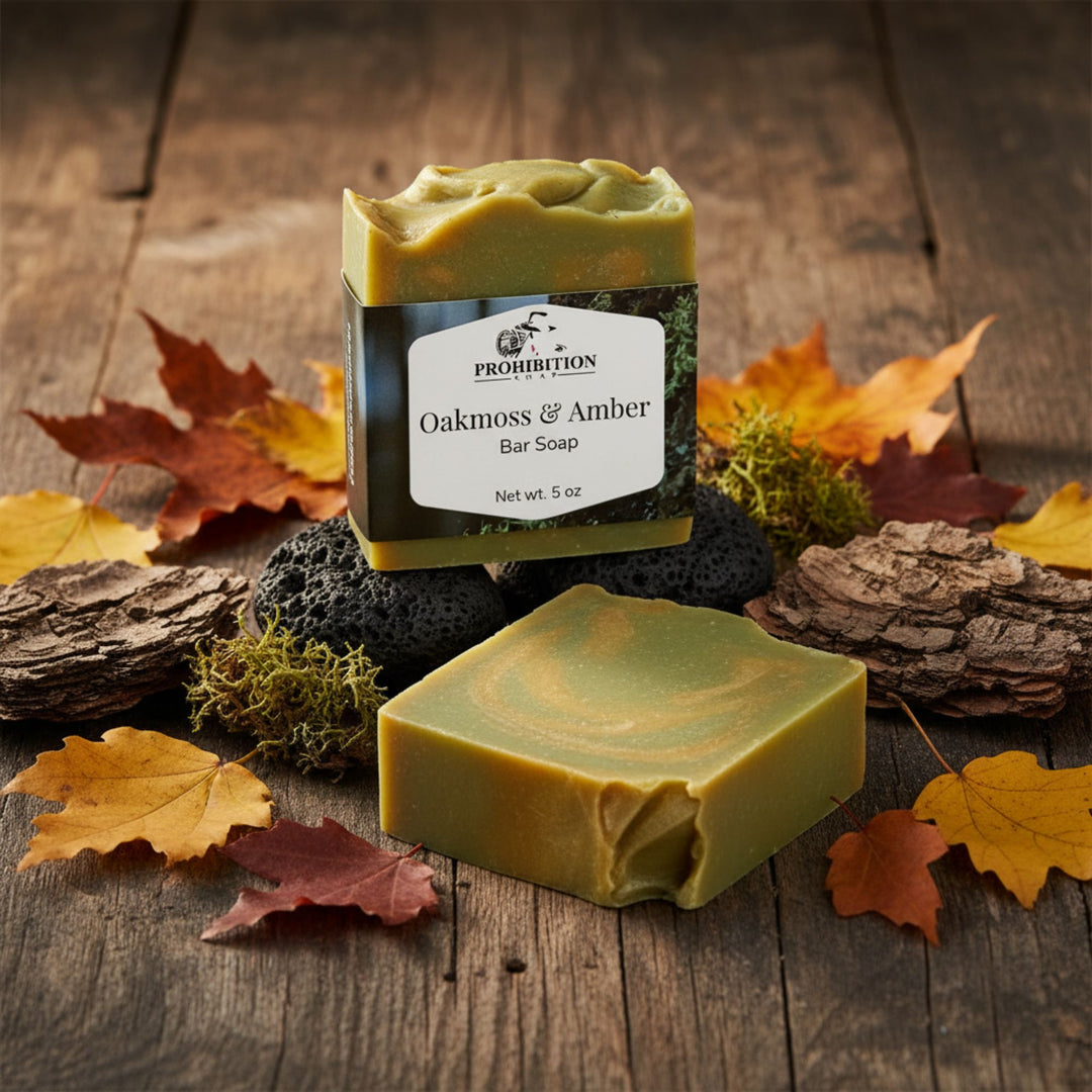 Two bars of soap, one with a label, on a wooden surface with autumn leaves and natural elements.