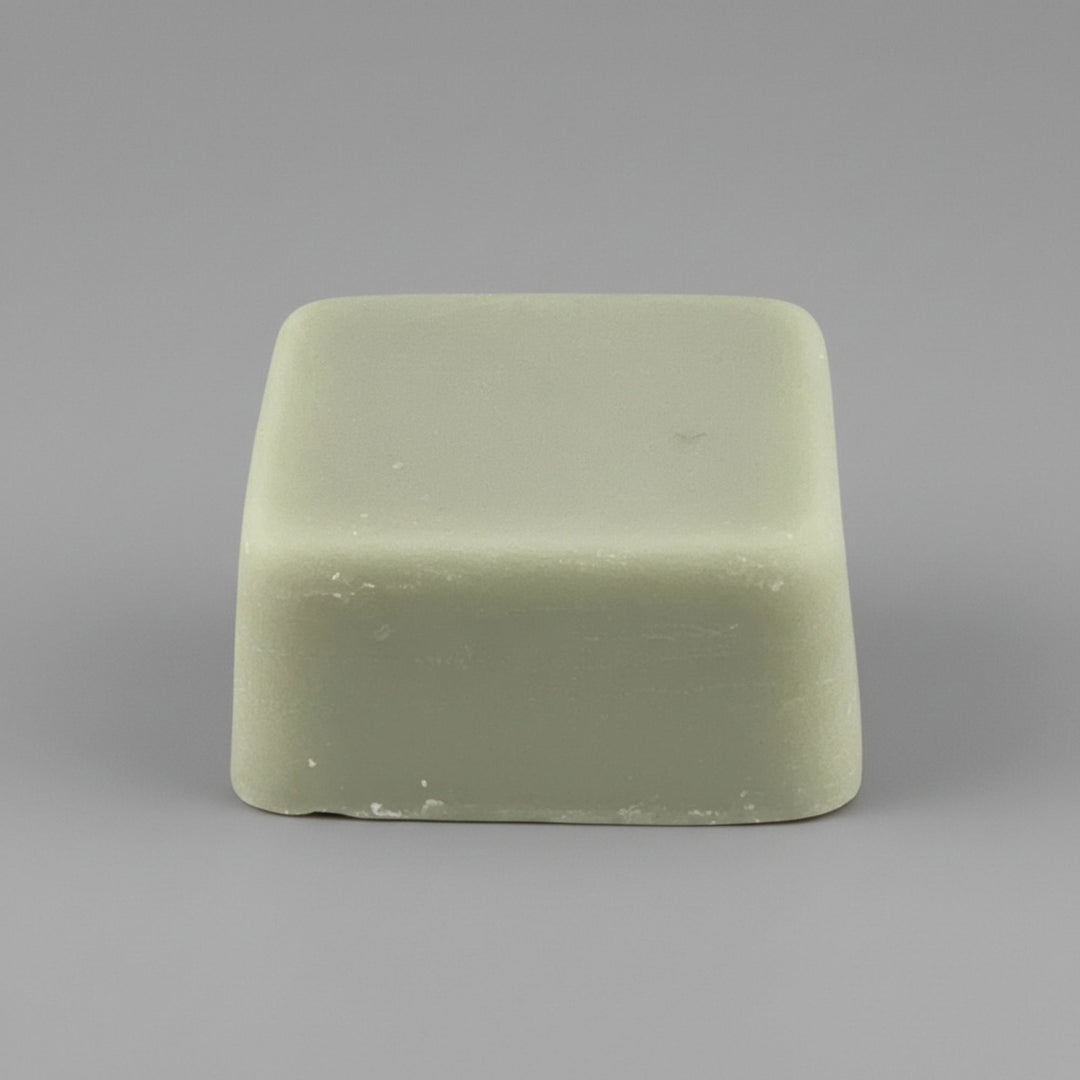 Rectangular green wax melt on a gray background