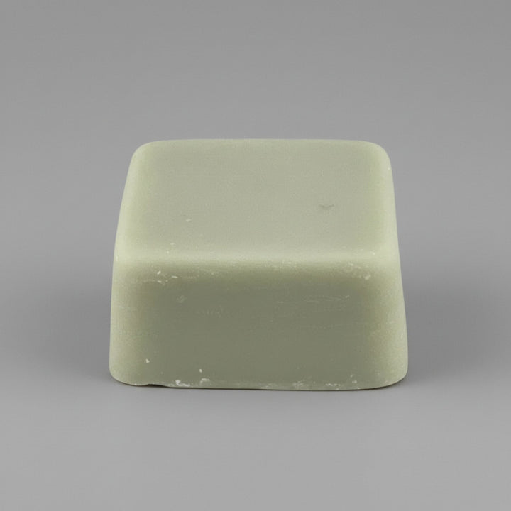 Rectangular green wax melt on a gray background