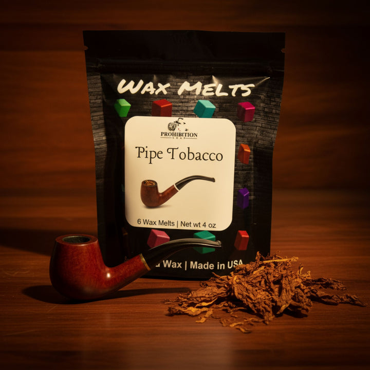 Pack of Wax Melts Pipe Tobacco with a red pipe and tobacco leaves on a wooden surface