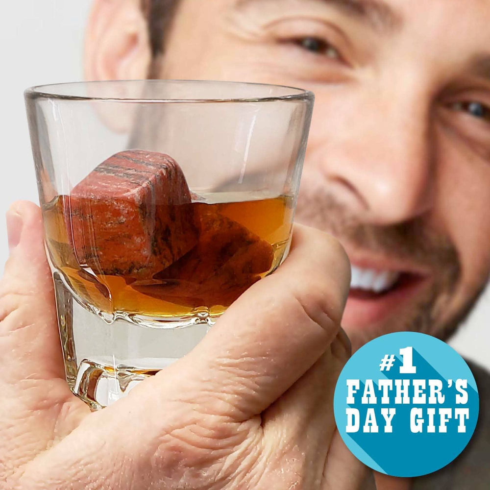 Man holding a glass of whiskey with a red stone, labeled '#1 Father's Day Gift'.