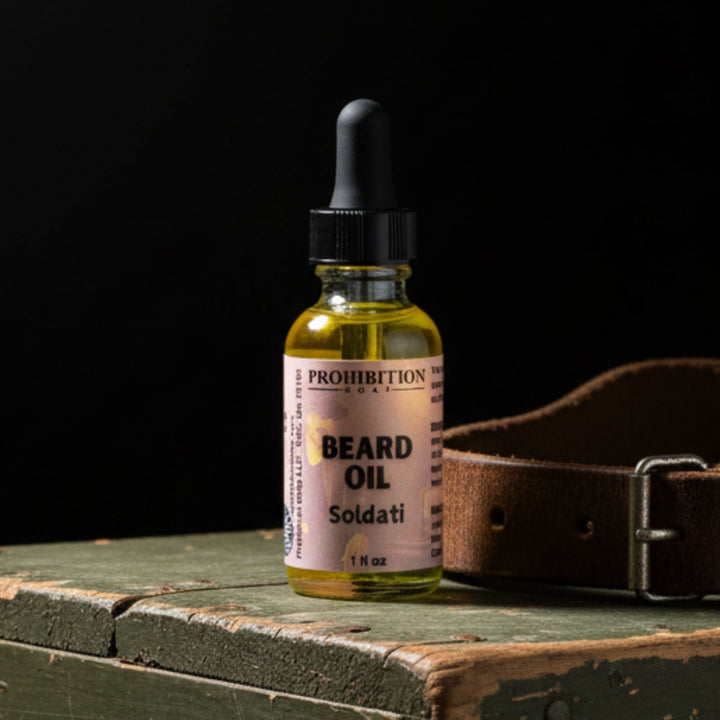 Bottle of Prohibition Beard Oil with a leather belt on a wooden surface