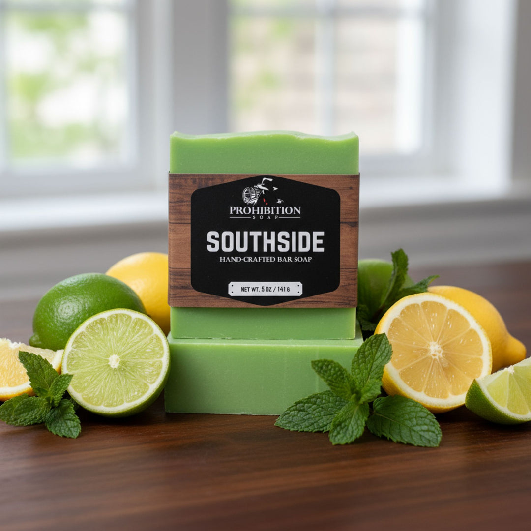 Green bar of soap with 'Southside' label surrounded by lemons and limes on a wooden surface.