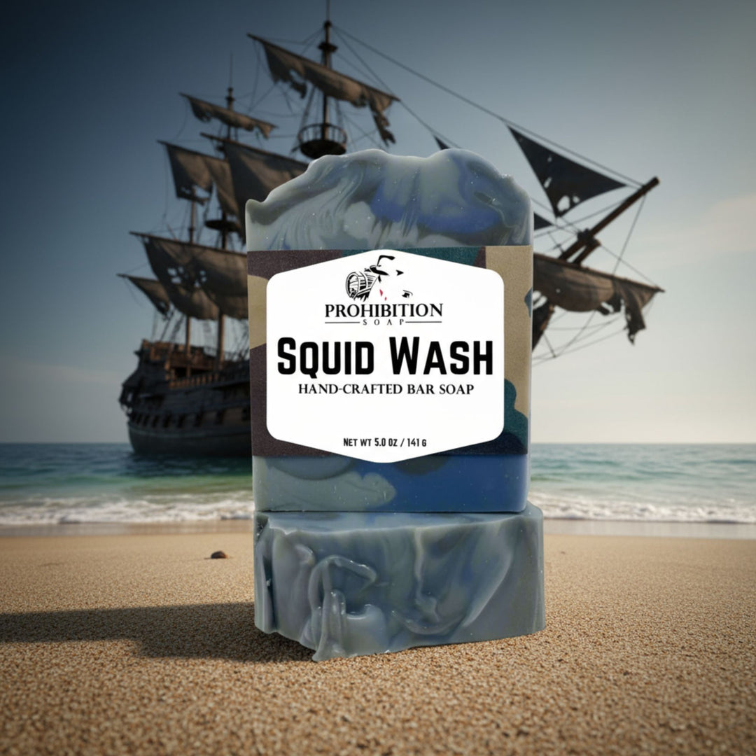 Bar of soap labeled 'Squid Wash' with a ship in the background on a beach.
