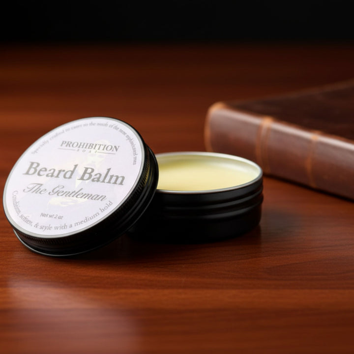 Beard balm container on a wooden surface with a book in the background