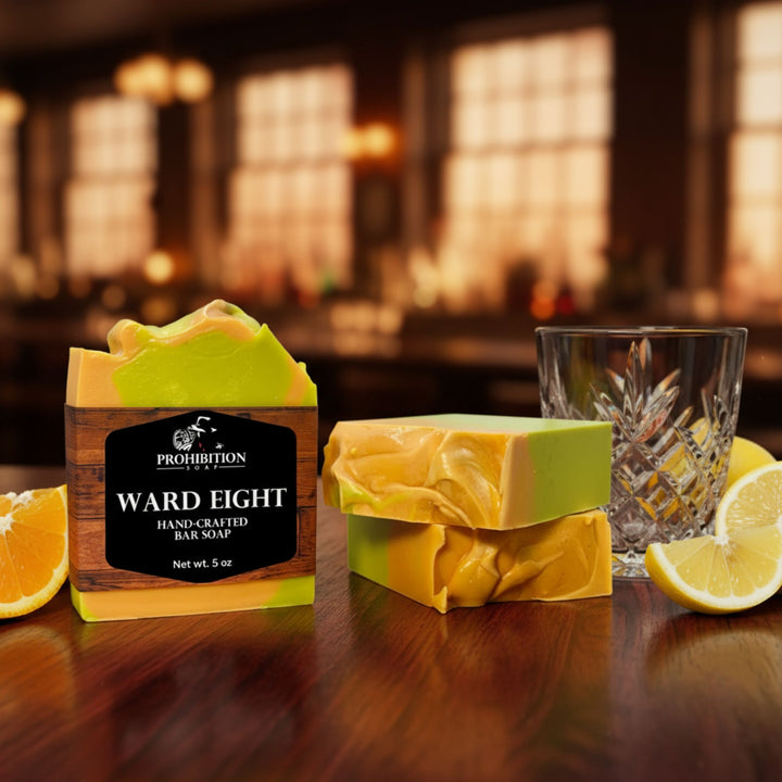 Ward Eight soap bar with packaging on a wooden surface with lemons and a glass.