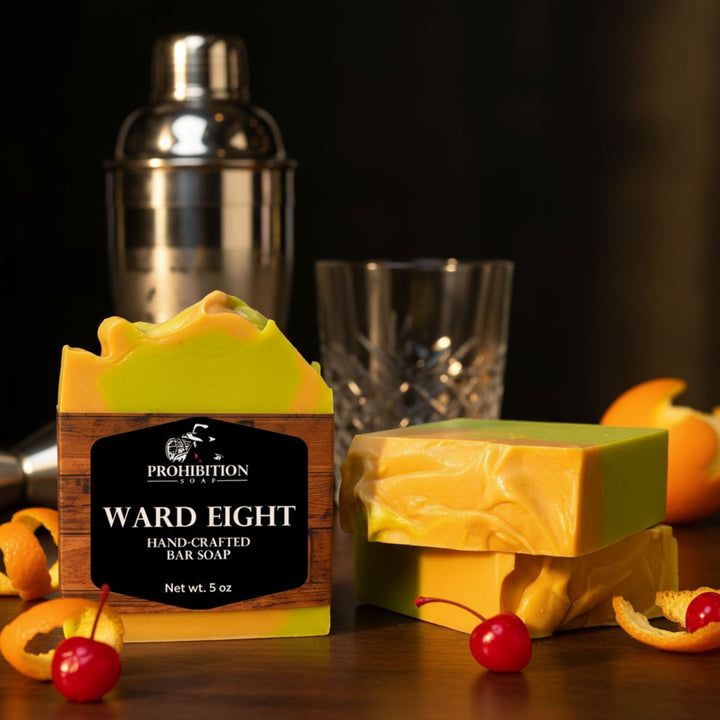 Two bars of soap with a 'Prohibition' label on a dark surface with a cocktail shaker and glass in the background.