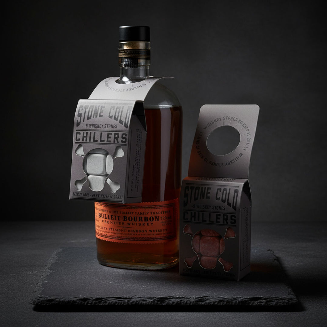 Bottle of whiskey with 'Stone Cold Chillers' packaging on dark slate background.